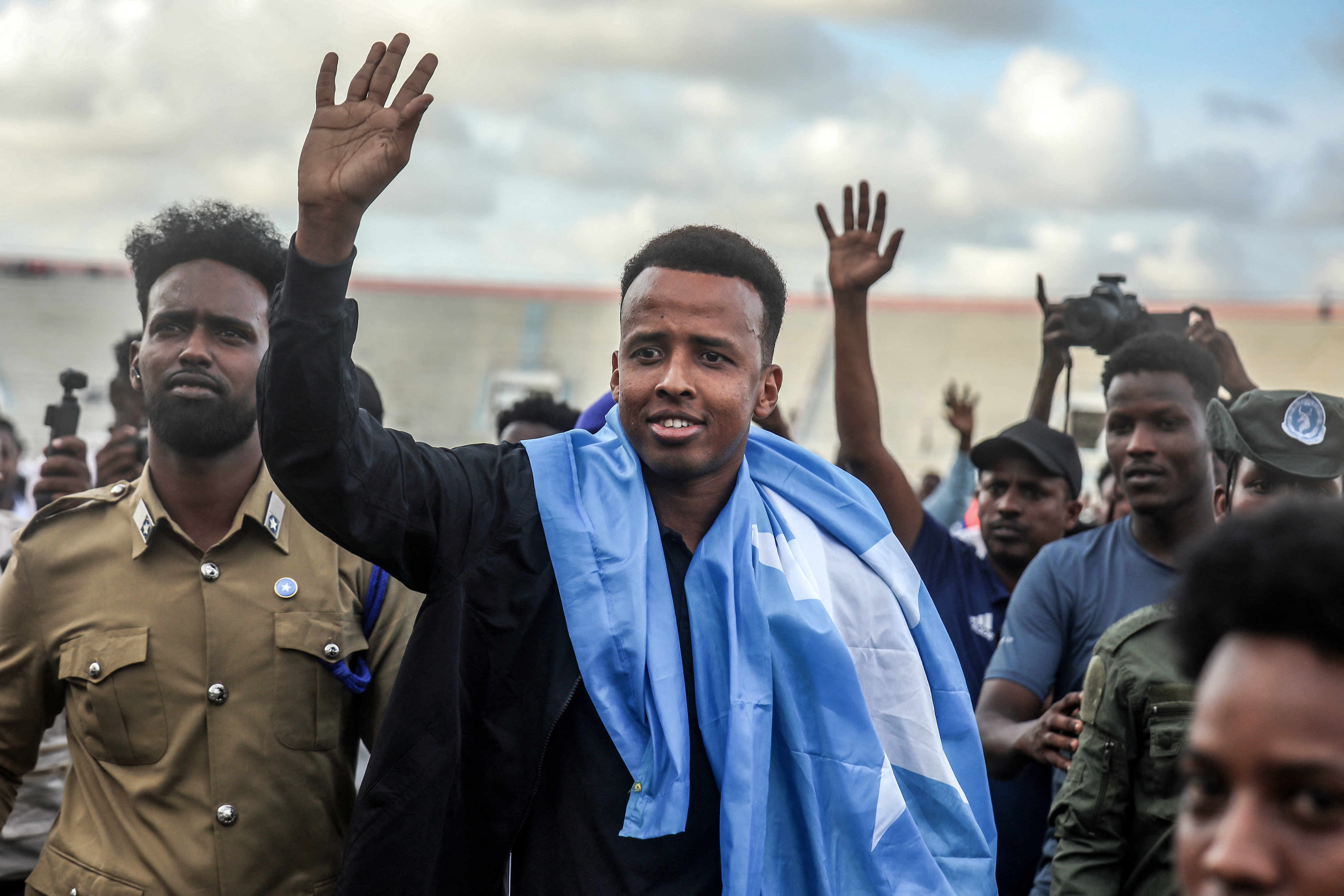 Somali international referee Omar Abdulkadir Artan waves to supporters while draped in the Somali flag as he is welcomed ahead of a solidarity football match after returning to Somalia in Mogadishu on June 10, 2026. Somali referee Omar Artan, who was denied entry to the United States for the World Cup, returned to a hero's welcome in Mogadishu and vowed to take part in the next tournament in 2030. Artan's rejection has sparked outrage at home.Artan, who in 2025 was named men's referee of the year by the Confederation of African Football (CAF), was barred from entering the US on Saturday after arriving at Miami International Airport.
Hassan Ali Elmi / AFP