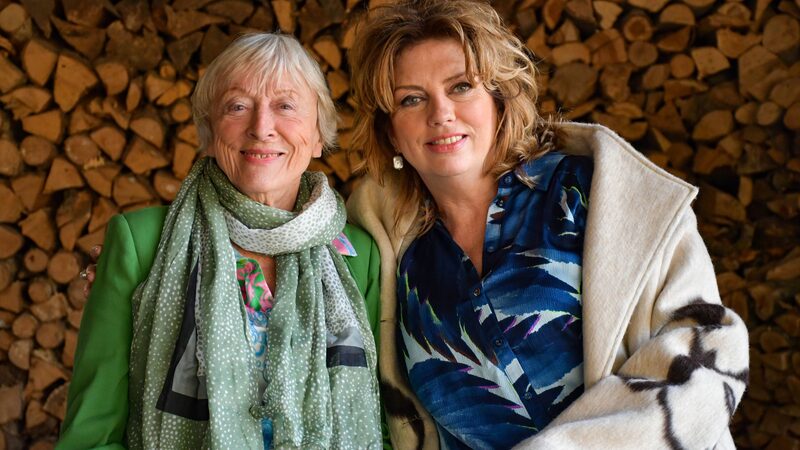 Margreet Honig en Annemiek Schrijver voor een stapel hout