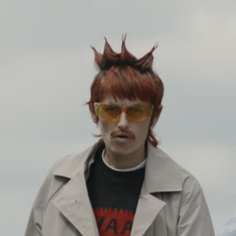 Rapper en performer Elmer heeft rode stekels en kijkt de camera in