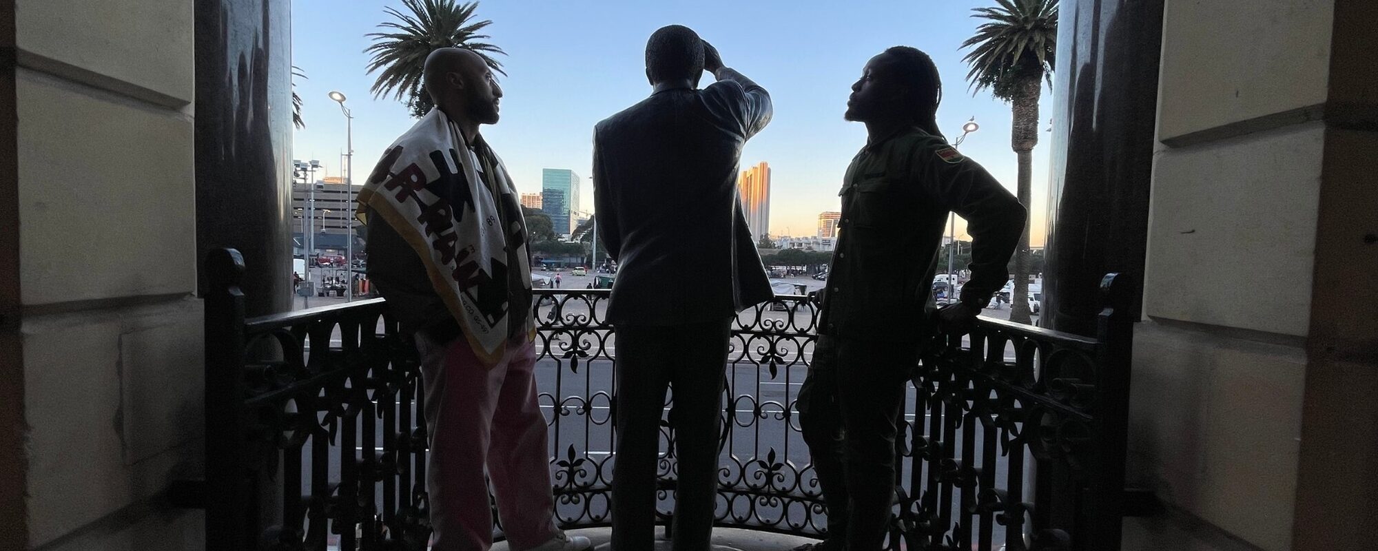 Akwasi Ansah en Gianni Lieuw-A-Soe bij een beeld van Nelson Mandela