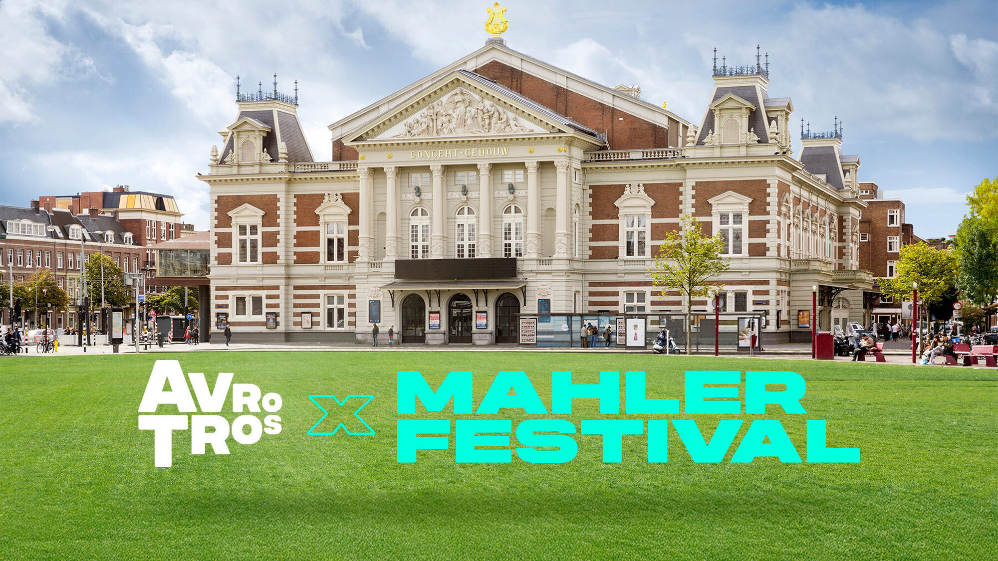 een foto van het concertgebouw in amsterdam. je ziet ervoor een stuk grasveld waar de letters 'avrotros x mahler festival' overheen zijn geplakt.